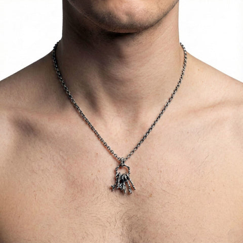 Necklace with a spider pendant worn by a person on a white background