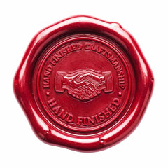 A round red wax seal with a scalloped edge, featuring an embossed handshake in the center and the words 'HAND FINISHED CRAFTSMANSHIP' and 'HAND FINISHED' around it, shown on a plain white background.