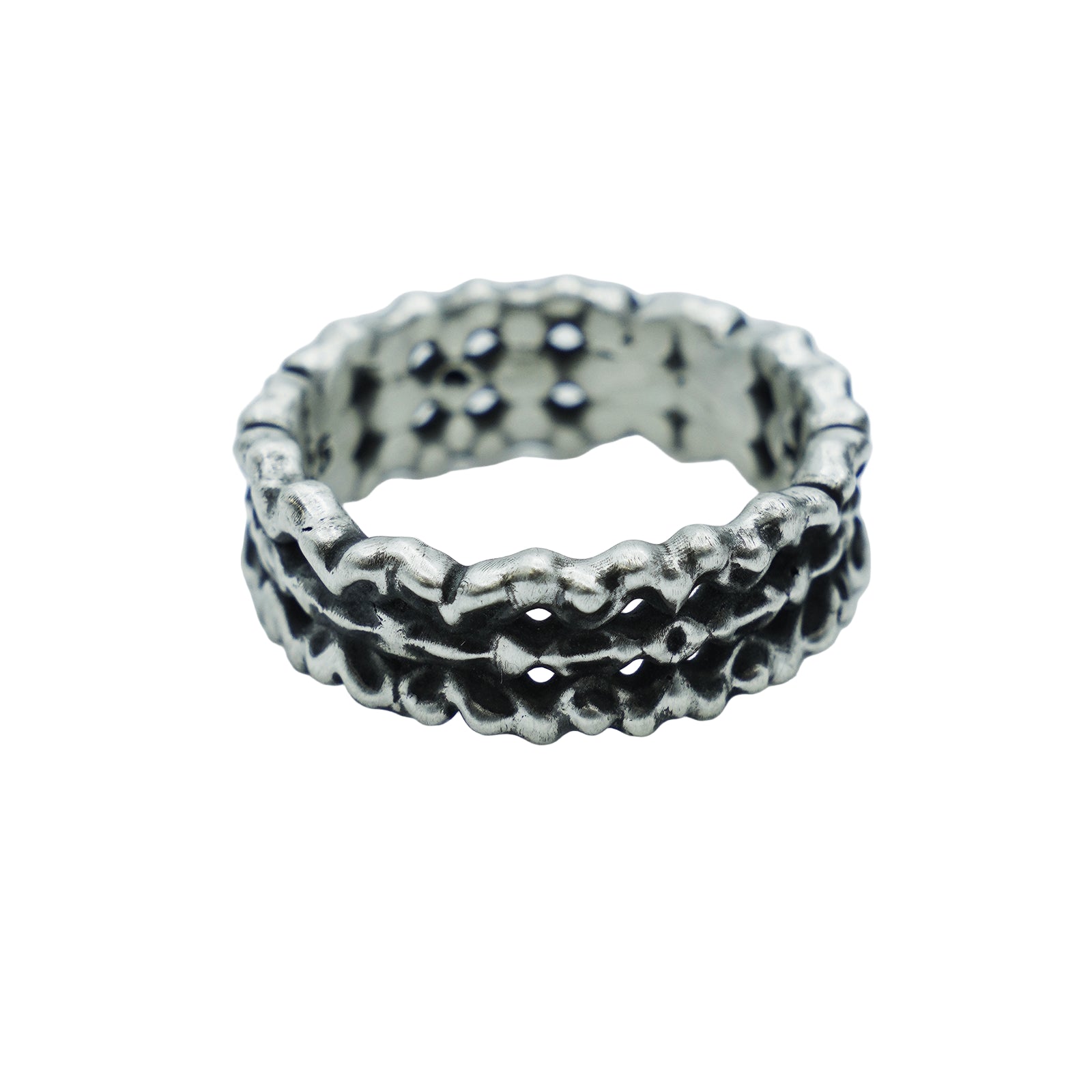 Silver ring with textured design on a light gray background