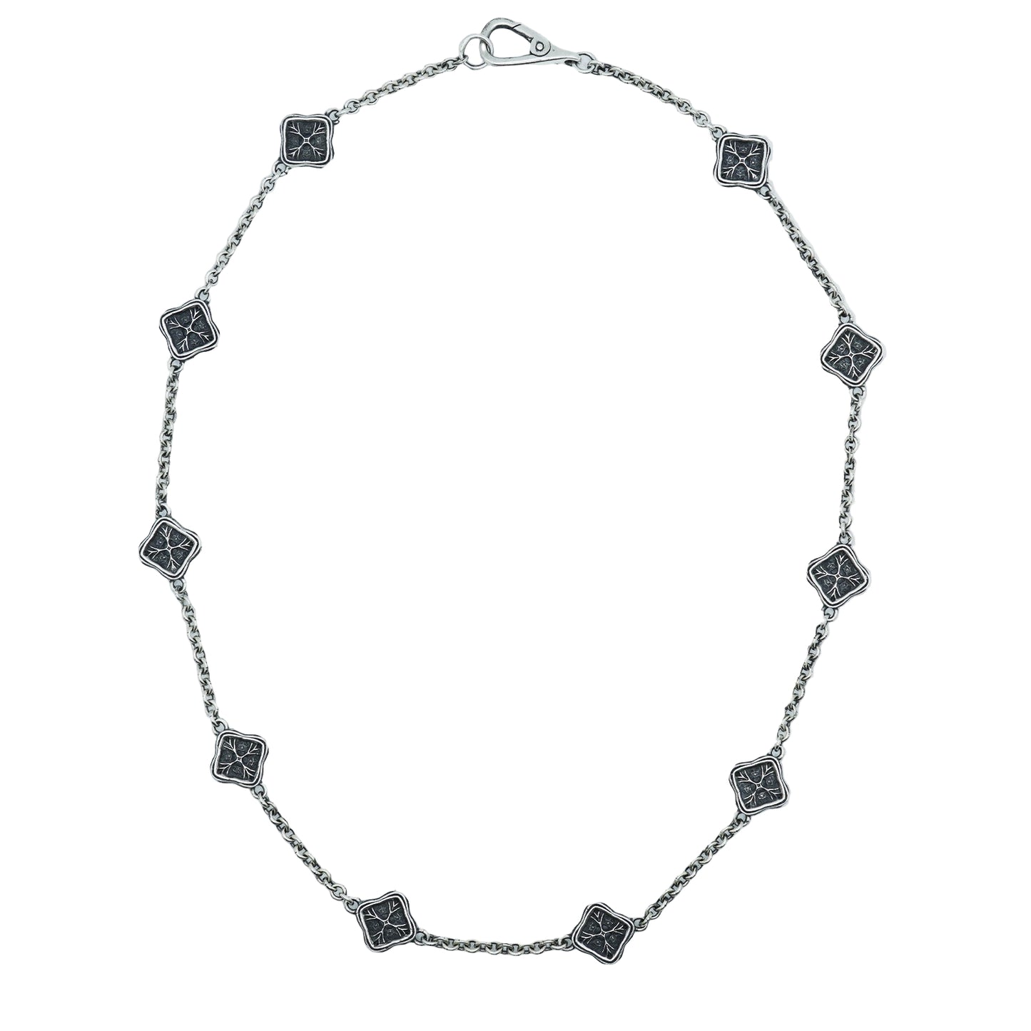 Silver necklace with square black stone pendants on a white background