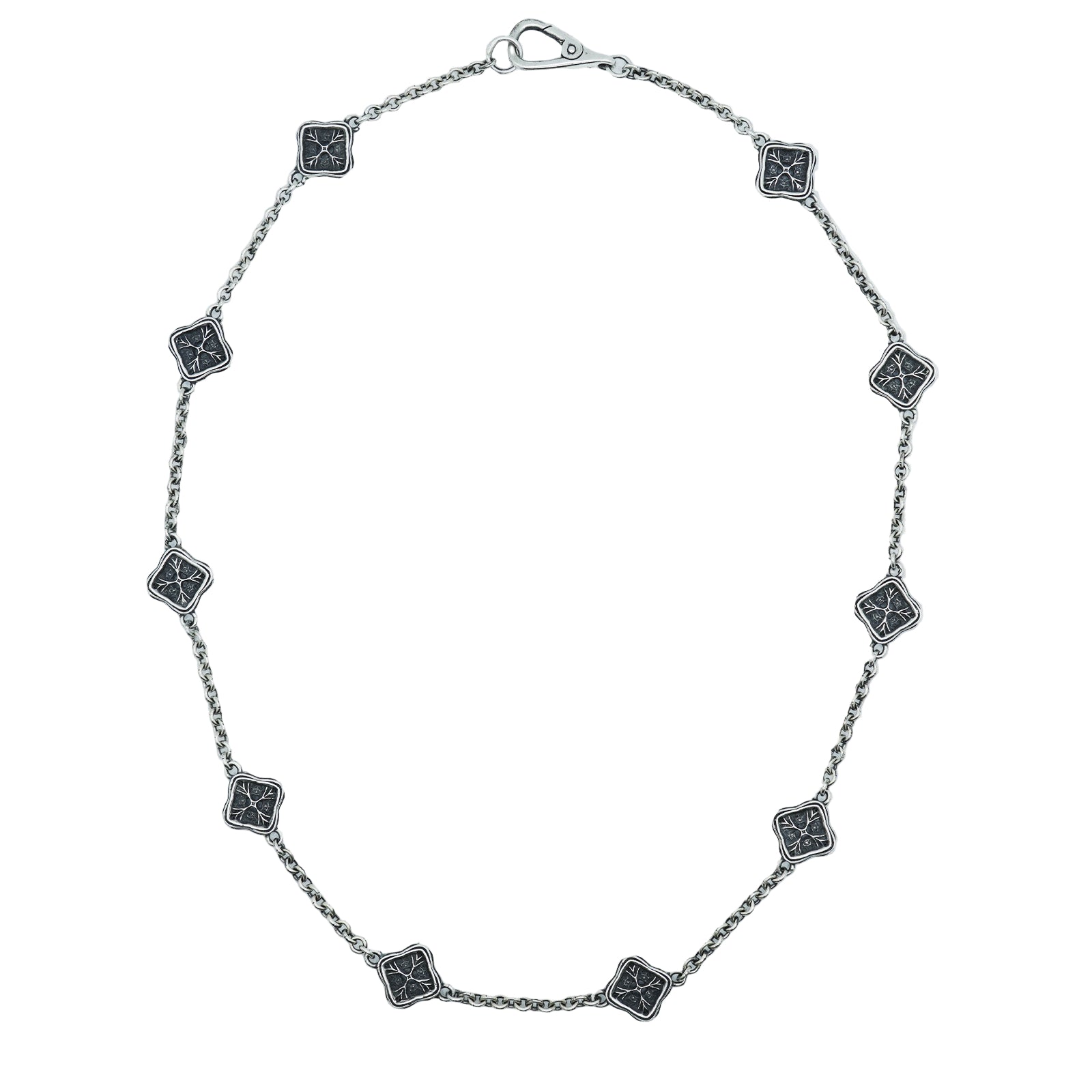 Silver necklace with square black stone pendants on a white background