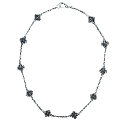 Silver necklace with square black stone pendants on a white background