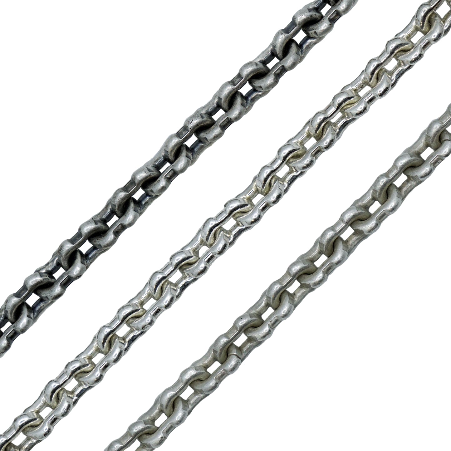 Two silver chains on a white textured background