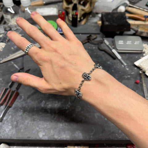 Hand-finished massive 925 Sterling Silver bracelet model AGONY with highly detailed screaming face pendants in a dark oxidized finish by frantic studio