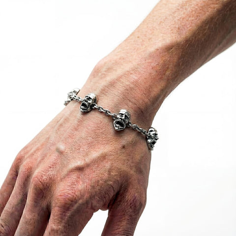 Hand-finished massive 925 Sterling Silver bracelet model AGONY with highly detailed screaming face pendants in a dark oxidized finish by frantic studio