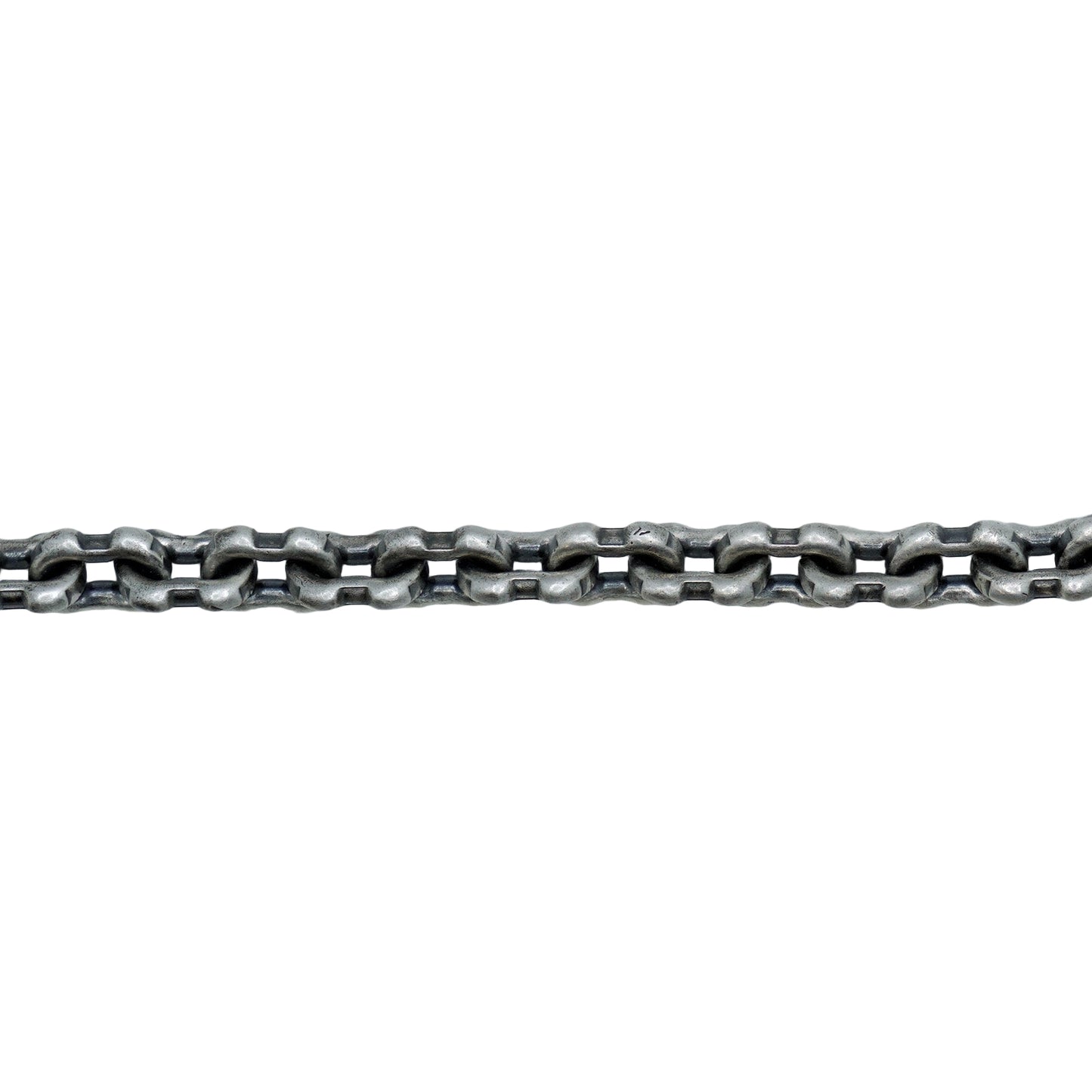 Metallic chain on a textured white surface with a light gray background