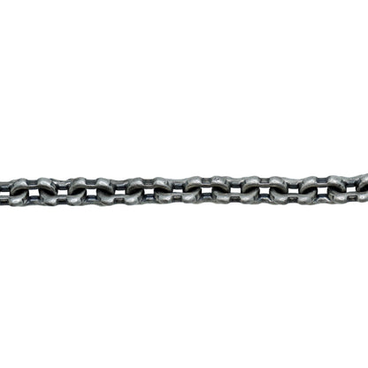 Metallic chain on a textured white surface with a light gray background