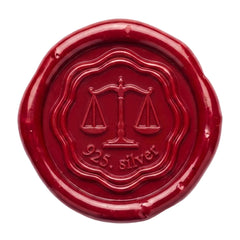 A round red wax seal with embossed details, featuring a scale of justice symbol and the text '925. silver' in the center, isolated on a white background.